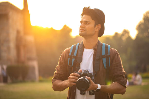 istock Thoughtful man with camera at historic site during vacation 1476699361