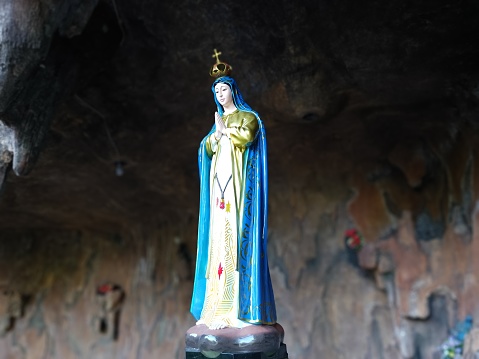 Bangka Island - Indonesia , 26 March 2023 : Tourist attractions Maria Cave, a portrait of the statue of the Virgin Mary standing on a globe