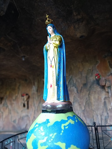 Bangka Island - Indonesia , 26 March 2023 : Tourist attractions Maria Cave, a portrait of the statue of the Virgin Mary standing on a globe