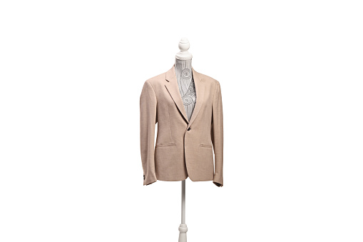 Studio shot of a torso mannequin with a beige suit isolated on white background