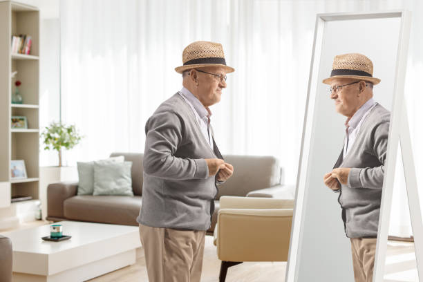 istock Elderly man getting dressed in front of a mirror 1476703105
