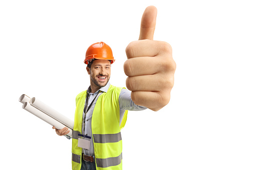 Engineer holding blueprints and showing thumbs up isolated on white background