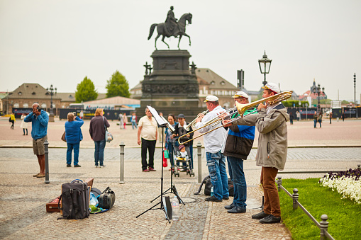 Young woman violinist playing the violin on the street in Vienna.