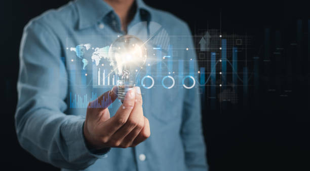 istock Businessman holding glowing light bulb with sales data analysis concept and economic growth graph. 1476703584