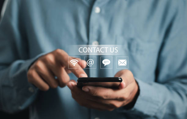 istock Contact us. businessman using smartphone with icon (wifi, address, chat, email) . Support concept. 1476703630
