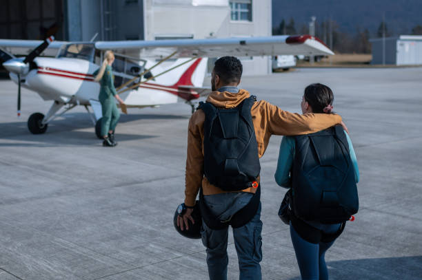 istock Two parachuting friends are preparing to jump with a parachute. 1476704268