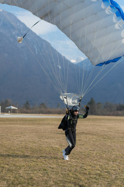 istock Skydiving woman touches the ground. 1476704552