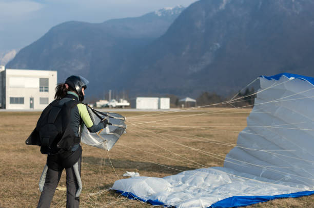 istock Skydiving woman touches the ground. 1476704576