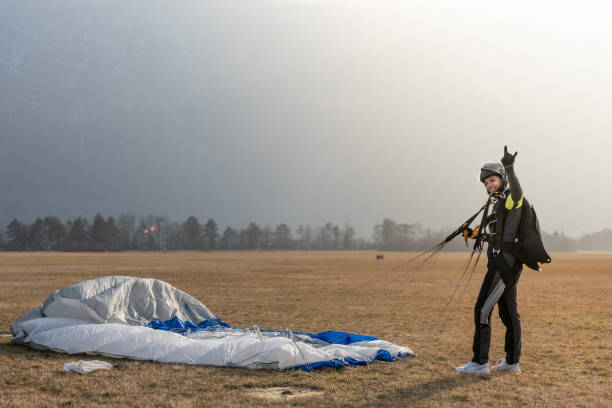 istock Skydiving woman touches the ground. 1476704583