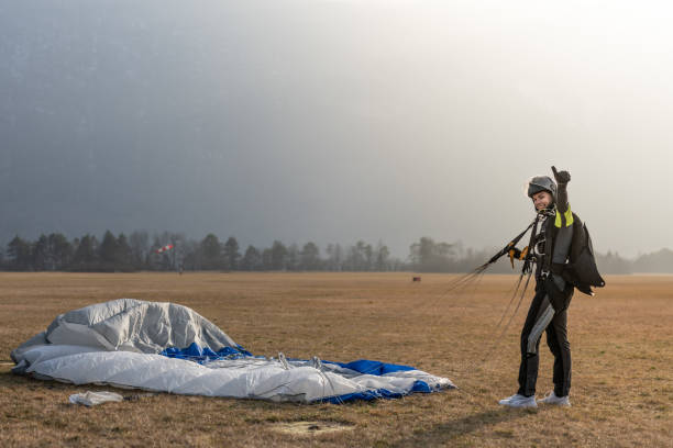 istock Skydiving woman touches the ground. 1476704584
