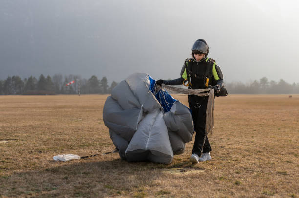 istock Skydiving woman touches the ground. 1476704592