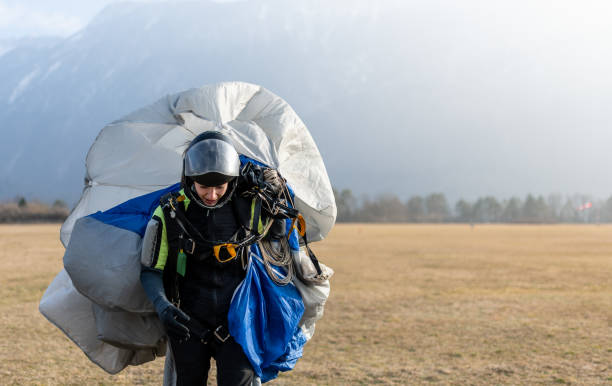 istock Skydiving woman touches the ground. 1476704620