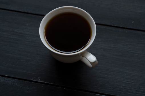 Cup of coffee on wood