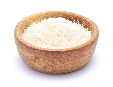 grated Parmesan cheese in wooden bowl isolated on white background.