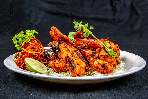 Indian cuisine traditionaly baked prawns on a hand made oven called tandoor. It is called Tandoori Prawn or Jhinga Tandoori a mouth watering appetizer.