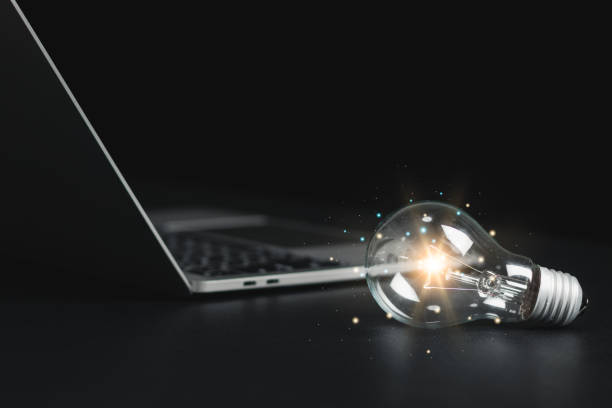 istock Glowing light bulb on the table, new ideas, inspiration, creativity with light bulb and innovation. 1476707873