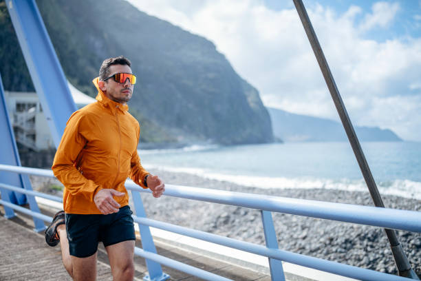 istock Man enjoying morning jogging near the ocean. 1476709178