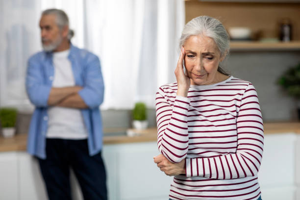 portrait of upset elderly couple standing in kitchen interior after argue - two parent family indoors home interior domestic kitchen imagens e fotografias de stock