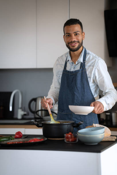 istock Friends prepare and cook lunch 1476710690