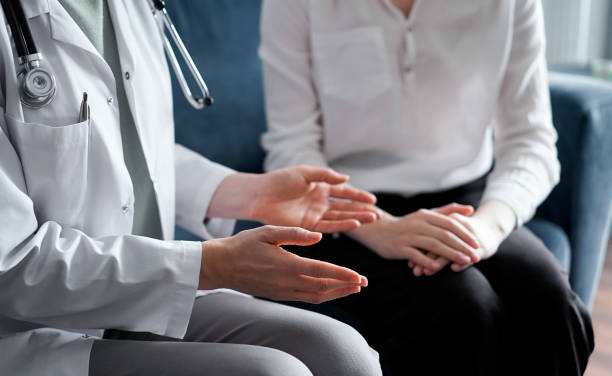 istock Unknown doctor and patient discussing current health examination while sitting at sofa, closeup. Medicine concept 1476711538