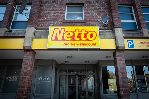 Picture of the Netto Discount sign on one of their stores of Dortmund, Germany. Netto Marken-Discount (also known as just Netto, formerly Plus) is a German discount supermarket chain owned by the German supermarket cooperative Edeka Group, and operates mostly in the south and west of Germany. The company reached its 1000th store in 2004, then aggressively expanded to the 4000th store in 2009, making it the largest discounter in Germany