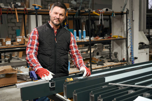 istock Smiling male working in protective gloves in the workshop 1476714100