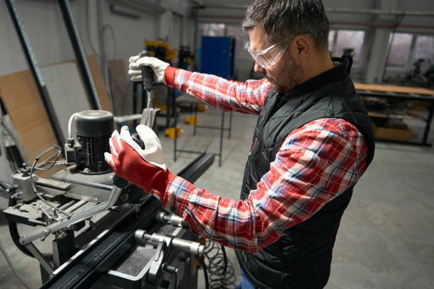 istock Adult man working at machine in the workshop 1476714199