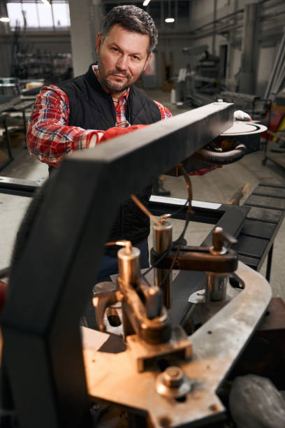 istock Adult worker working with metal parts constructions 1476714245