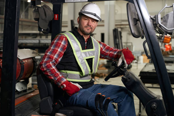 istock Worker sitting in loading truck and working at enterprise 1476714276