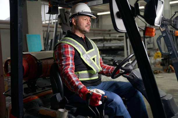 istock Male sitting in loading truck and working at enterprise 1476714284