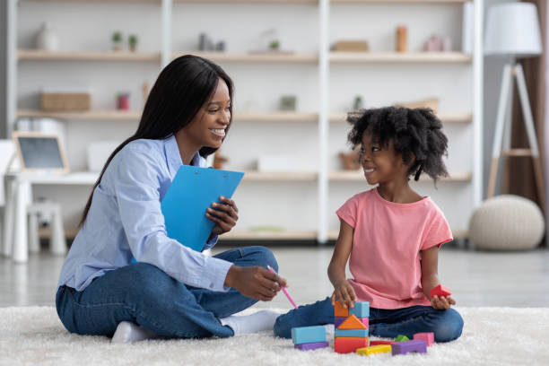 istock Excited african american kid and child psychotherapist playing with bricks 1476719749