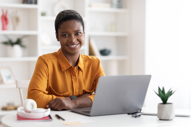 istock Pretty african american lady freelancer using laptop at home 1476722092