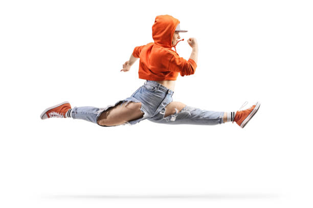 Female street dancer performing a split leap isolated on white background