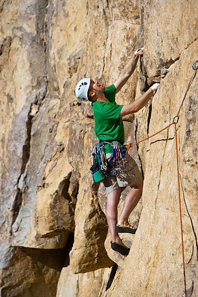 istock Rock climber clinging to a cliff. 147672261