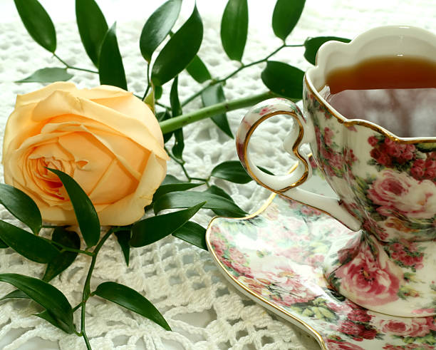 istock Cup of  tea and rose on knitted table cover 147672410