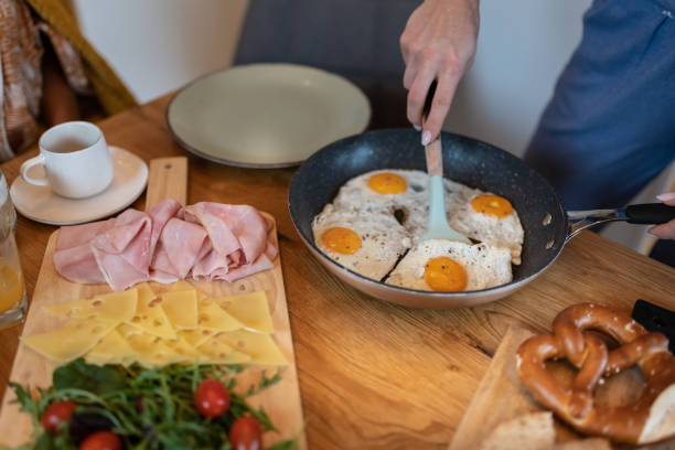 After last night's party, friends have a late breakfast this morning in their pajamas in a relaxed atmosphere. A healthy breakfast. International team, mixed races.