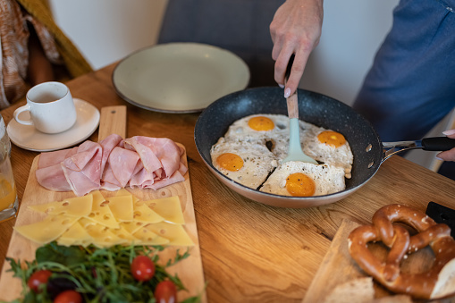 After last night's party, friends have a late breakfast this morning in their pajamas in a relaxed atmosphere. A healthy breakfast. International team, mixed races.