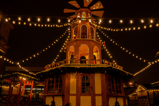 Holiday decorations of Coal Market - Targ Weglowy square in Gdansk Poland. Beautiful Christmas fair in the old town at night. Advent winter time in Europe background. Christmas Markets in December Ornamented for celebration