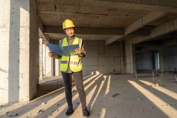 istock A female construction worker is working on a construction site with blueprints 1476729866