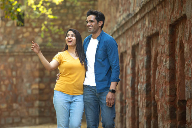 Smiling young couple spending leisure time together at ancient travel destination