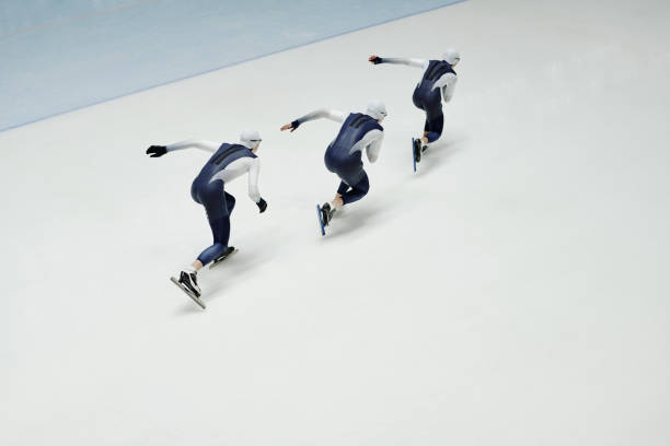 Small group of young athletes on skates practicing new motions while training on ice rink and preparing for important competition