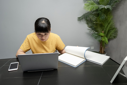 A female business worker is using a computer to work