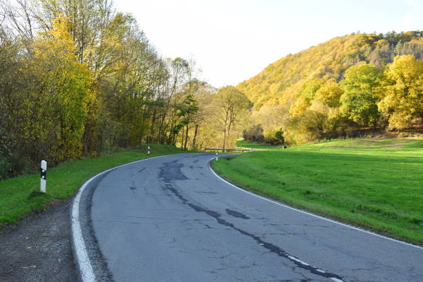 istock damaged and badly repaired road 1476733543