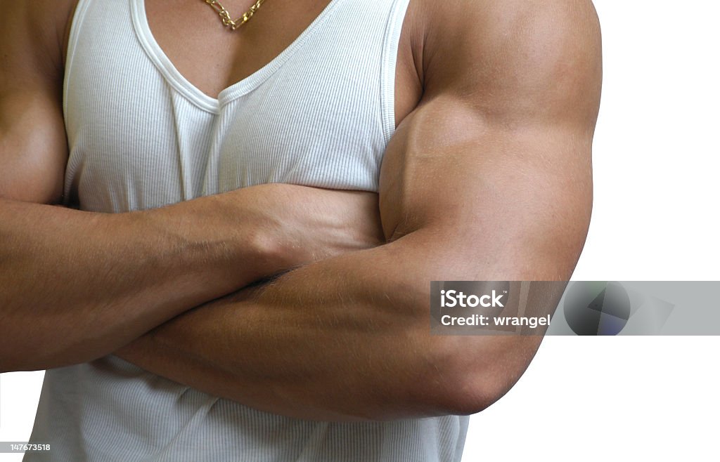 Close-up of a muscular male torso on a white background Muscular male torso in a white sleeveless shirt isolated on white Adult Stock Photo