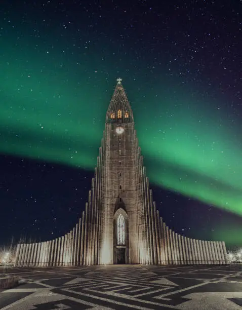 Photo of Hallgrims Church Hallgrimskirkja in Reykjavík Iceland with northern lights