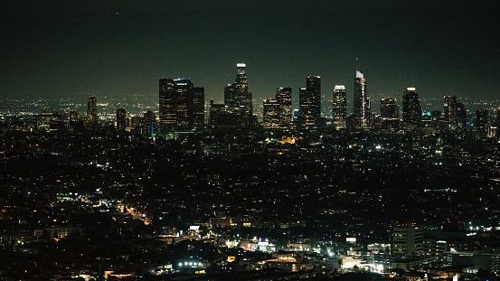 A night cityscape in silhouette at Los Angeles, showcasing the skyscrapers and the size of a massive city