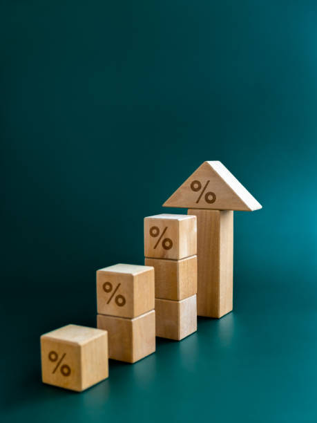 istock Percentage icon on wooden cube blocks bar graph chart steps with big arrowhead on blue background, vertical. Investment, income, trends, inflation, business growth, economic improvement concepts. 1476738469