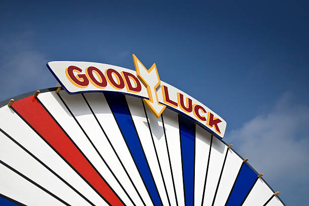 Carnival Fairground Good Luck Sign Red, white and blue carnival fairground good luck sign on wheel of fortune, with arrow. spinning photos stock pictures, royalty-free photos & images