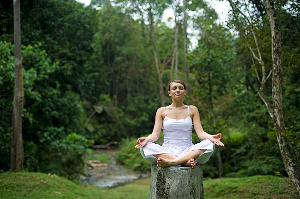 istock Woman meditating in Rainforest 147674063