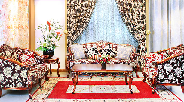 Nicely decorated living room with fireplace on. 